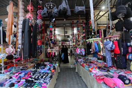 A Palestinian Vendor Displays Clothes At His Store Dair Al Balah Gaza