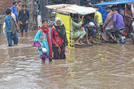 Pakistani People Wade Through Flooded Road Editorial Stock Photo