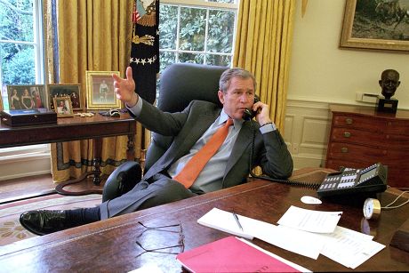 1 American President George W Bush Receives A Report On The Phone At