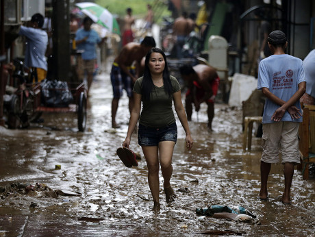 Filipino Flood Victims Maneuver Along Street Editorial Stock Photo