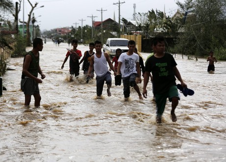 Filipino Typhoon Victims Maneuver On Floodwater Editorial Stock Photo