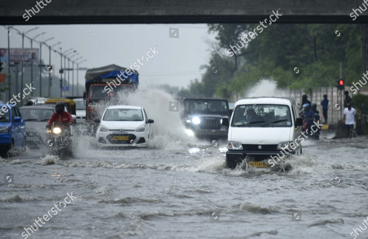 Vehicles Wade Through Waterlogged Stretch During Editorial Stock Photo