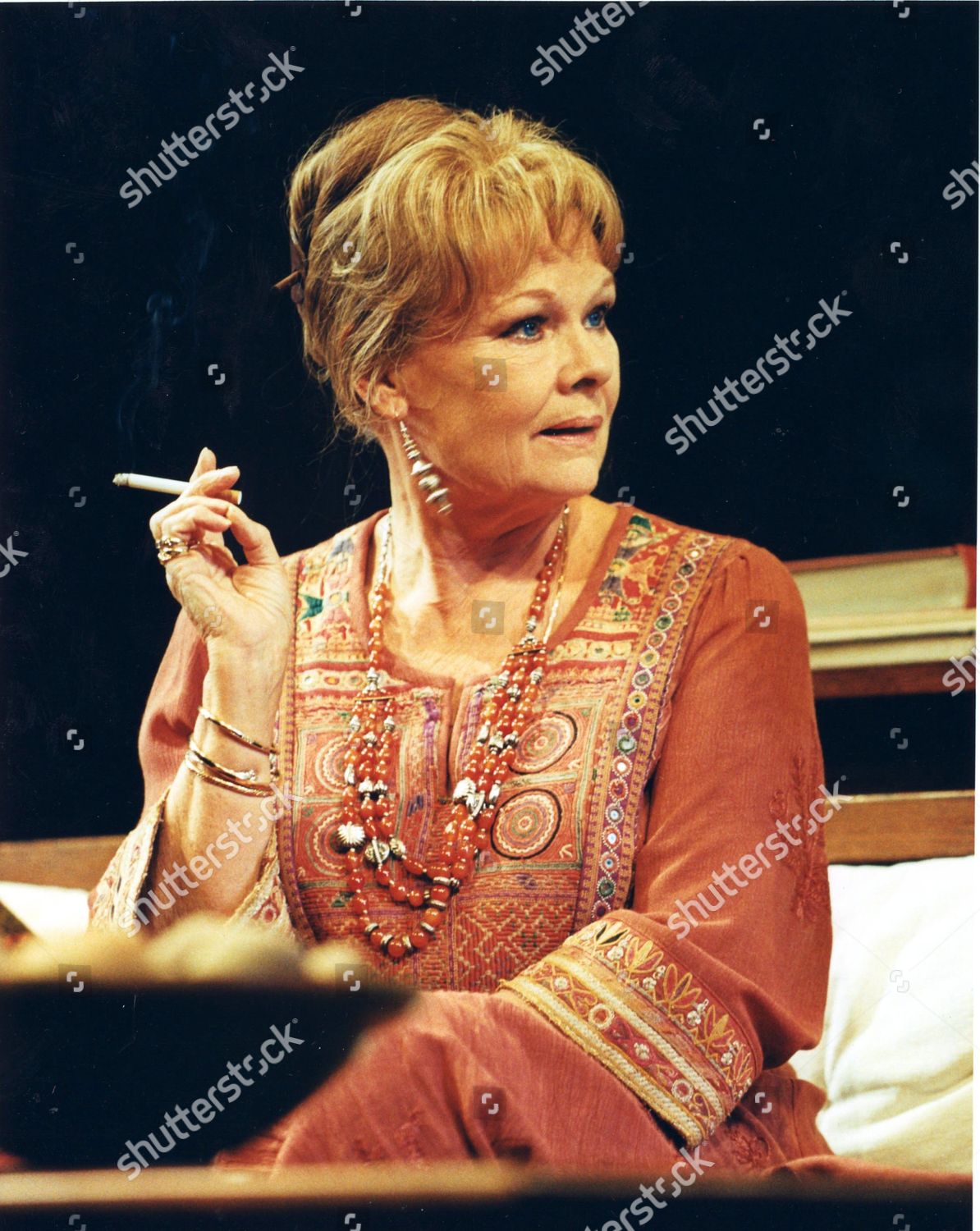 Judi Dench smoking a cigarette (or weed)

