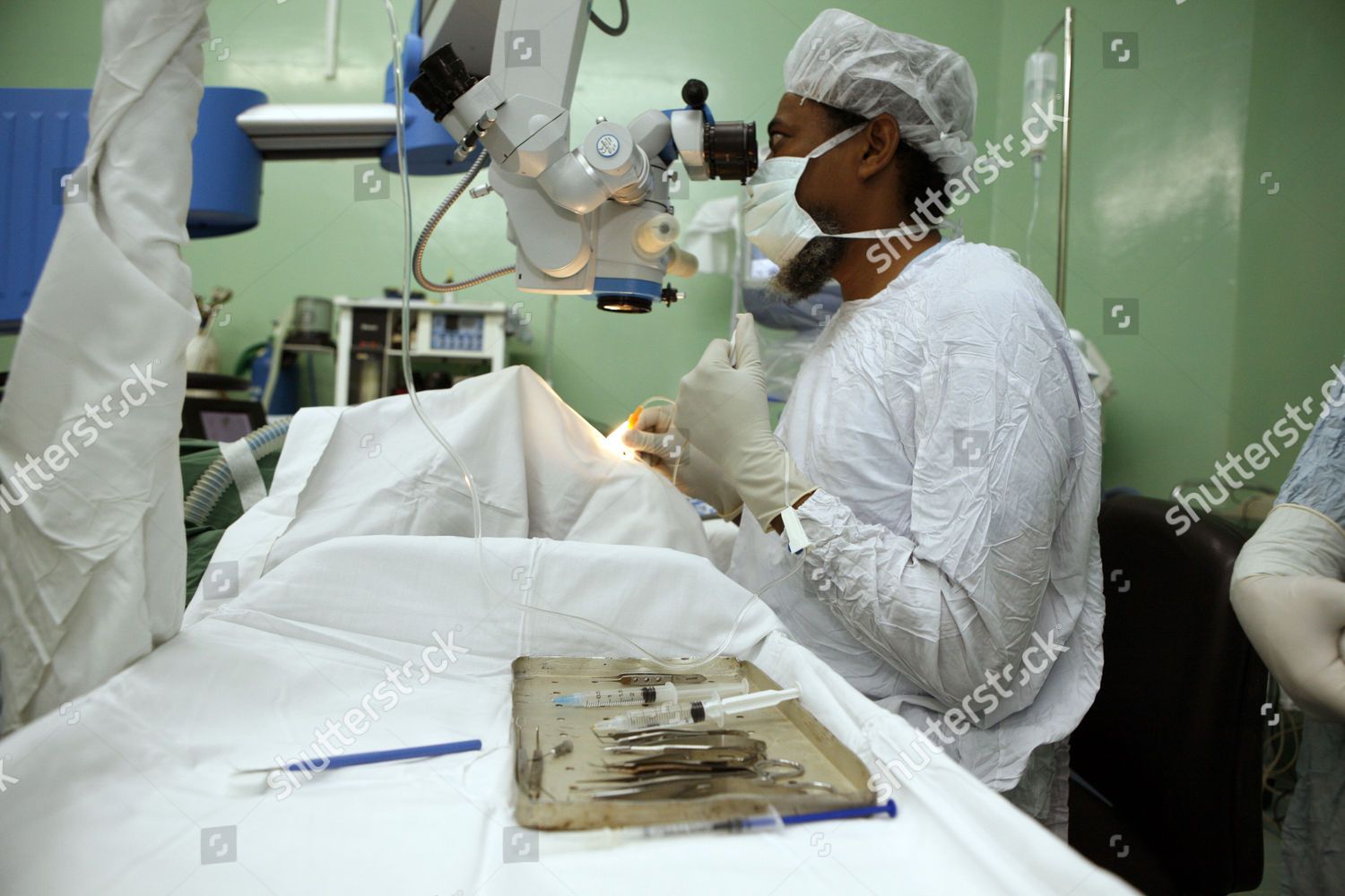 Model Released Surgeon Uses Microscope During Editorial Stock Photo