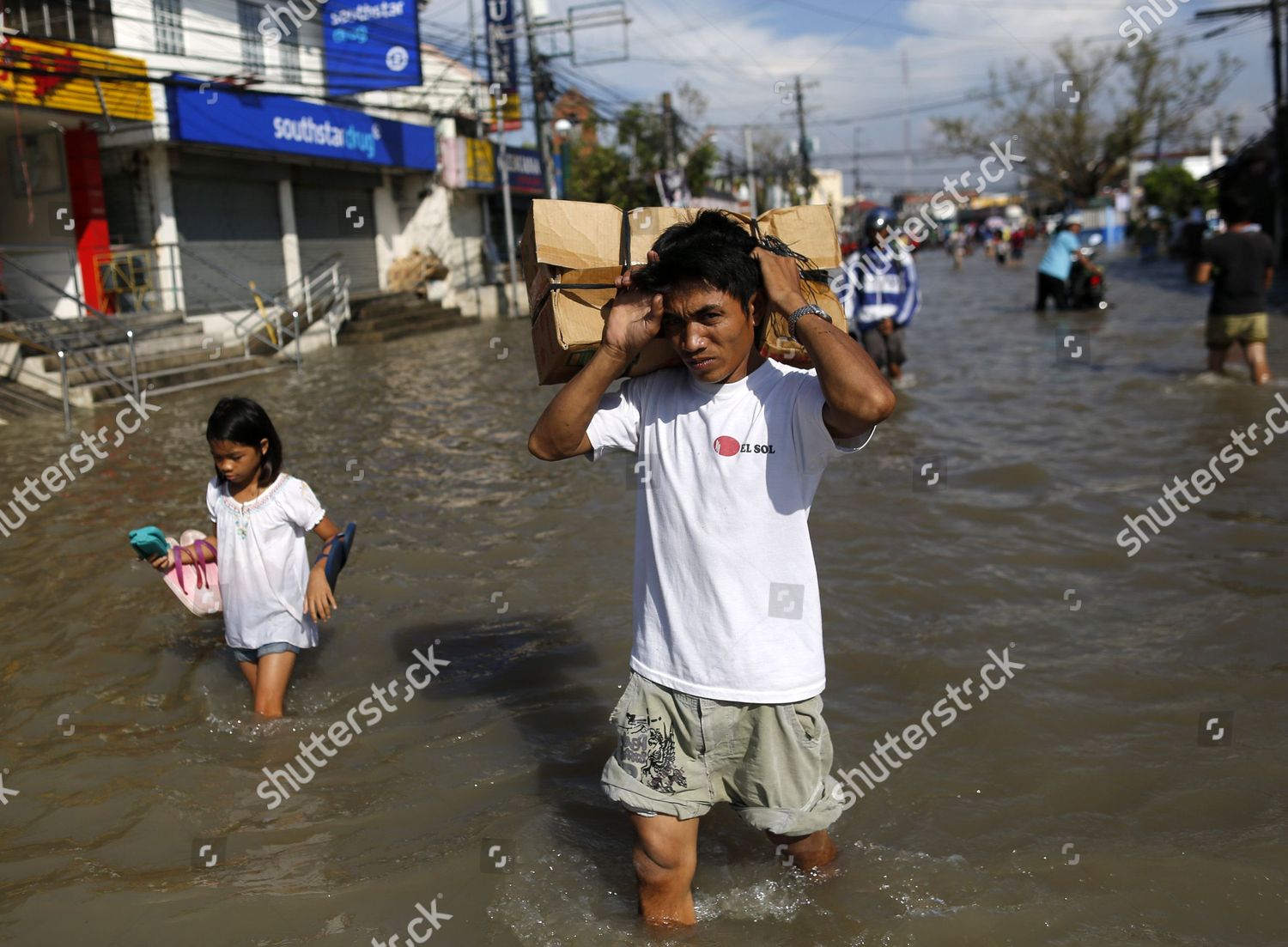 Filipino Flood Victims Wade Through Floodwater Editorial Stock Photo