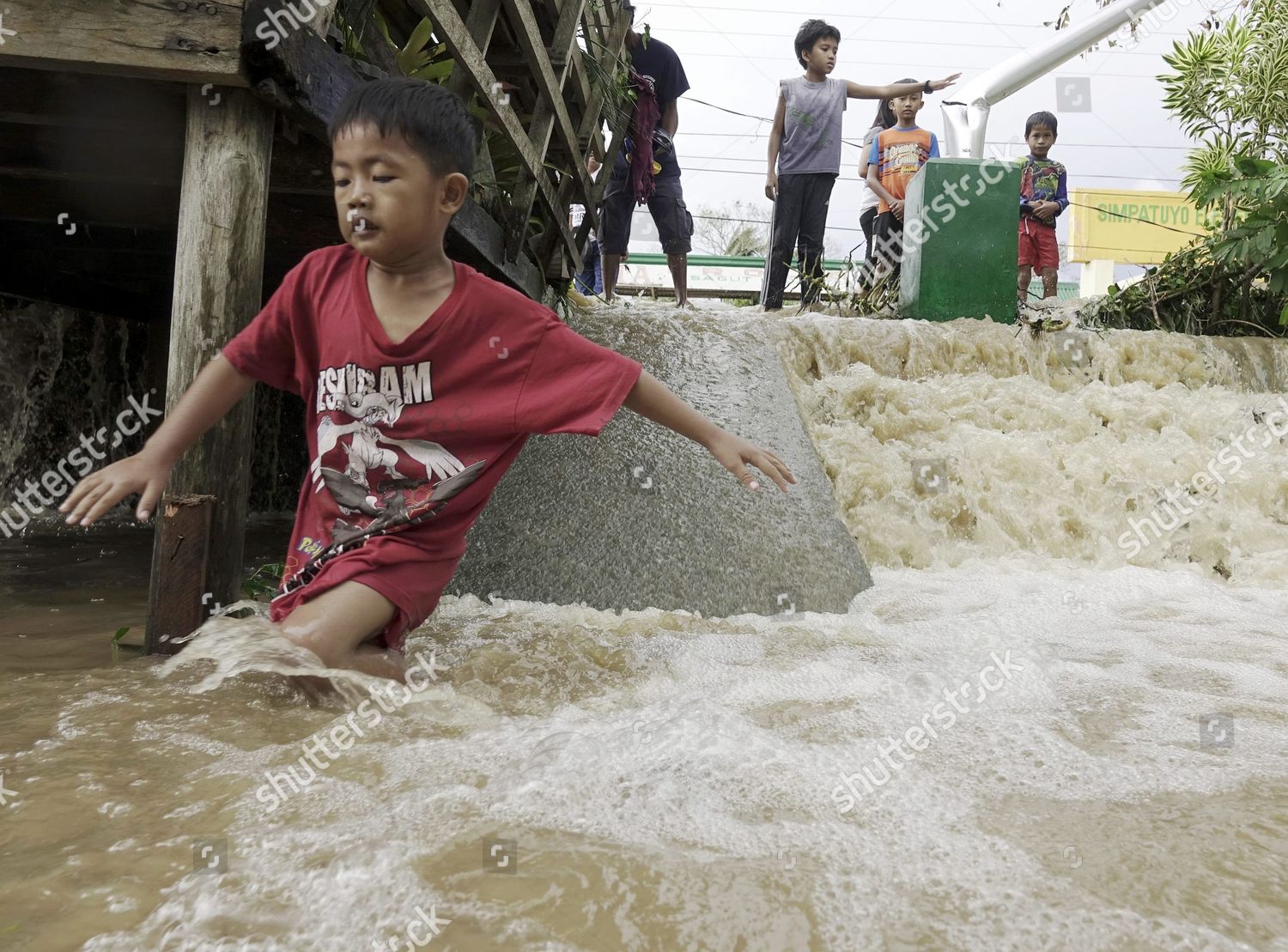 Filipino Typhoon Victims Maneuver On Floodwater Editorial Stock Photo