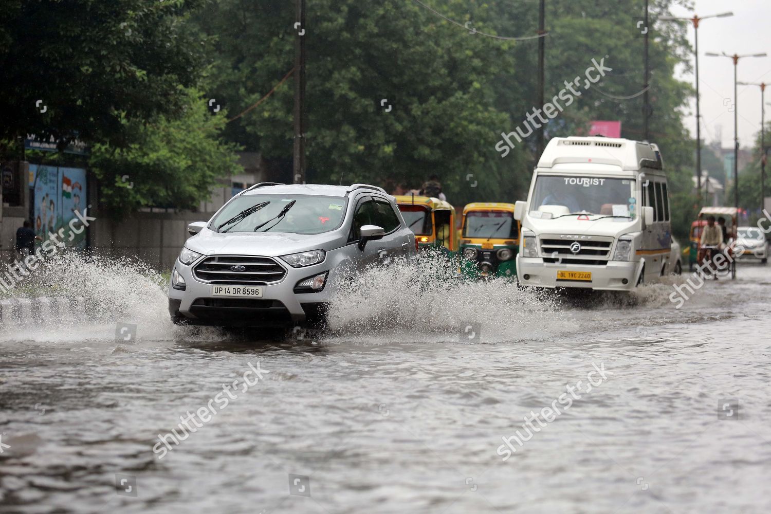 Vehicles Wade Through Waterlogged Street Near Editorial Stock Photo