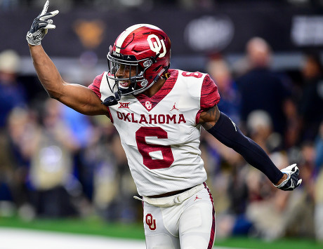 Texas Longhorns running back Keaontay Ingram (26) is stopped behind the  line by Oklahoma defensive lineman Kenneth Mann (55) during the Dr. Pepper  Big-12 Championship between the Oklahoma Sooners vs Texas Longhorns