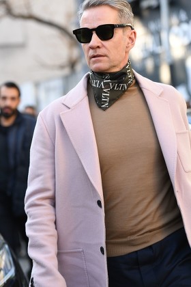 MILAN, ITALY - JANUARY 11, 2019: Man with black coat and Valentino