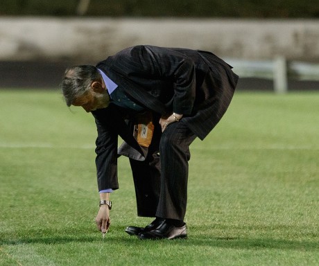 Cowdenbeath club Chairman Donald Findlay QC tries to dig his car keys into the pitch at Central Park shortly after Cowdenbeath's William Hill Scottish Cup 4th Round tie against Rangers. The match was postponed due to a frozen pitch.