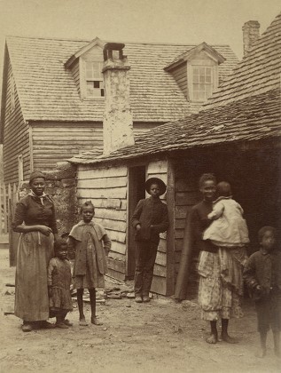 Portrait of an African American family standing in front of a house, St. Augustine, Florida, 1886. Photo by George Barker