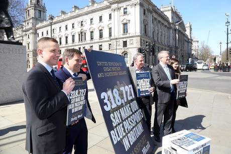 Mps Join The Daily Mail Campaign To Get Britain's Blue Passports Made In Britain. Mps Nigel Evans Andrew Rosindell And Andrew Bridgen Join Daily Mail Reporters Under The Gaze Of Winston Churchill In Parliament Square With The Signed Petitions.