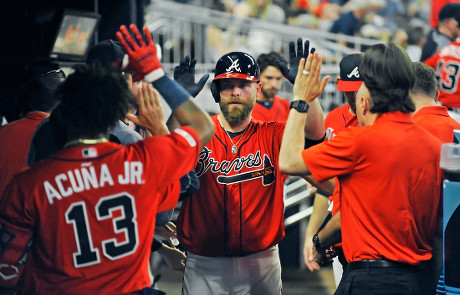 Atlanta Braves - Brian McCann celebrates in the dugout after his