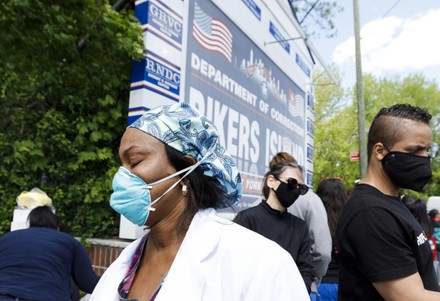 Nurse Neshia McDonald (L) composes herself after discussing a Rikers Island nurse colleague, William Chan, who died yesterday from COVID-19, during a rally organized by the New York State Nurses Association at the entrance to the Rikers Island correctional facility to protest and draw attention to the handling of COVID-19 patients and healthcare worker conditions at the prison in Queens, New York, USA, 07 May 2020. Prisons around the country are seeing large number of COVID-19 cases. New York City is still the epicenter of the coronavirus outbreak in the United States and hospital workers dealing with COVID-19 patients are struggling with a limited supply of protective equipment.