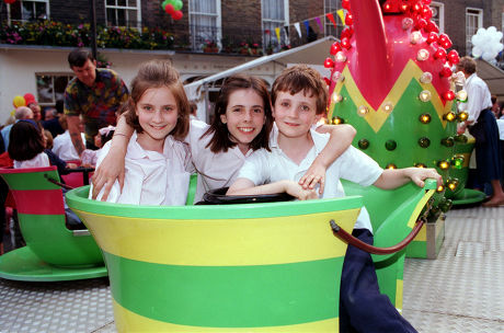 Belgravia Midsummer Carnival. Fun In A Tea Cup L-r Vicky Scurr (11) Julia Vali (12) And Tom Scurr (9) Enjoy The Merry-go-round.