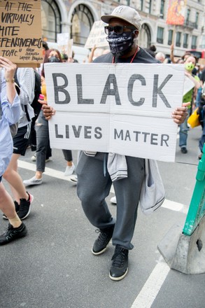 Man wearing a hooded top, sunglasses and Louis Vuitton Face Mask, at the  Black Lives Matter UK protest in Parliament Square. London, England UK  Stock Photo - Alamy