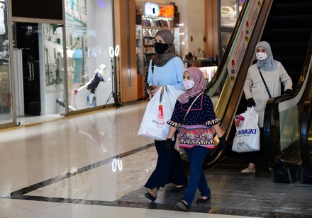 Shopper Wearing Face Mask Walks Past Editorial Stock Photo - Stock