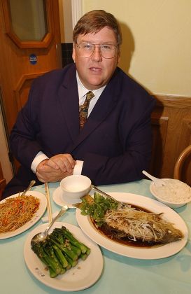 Evening Standard Food Critic Charles Campion Dines Out On Koi Carp Cooked In Ginger And Spring Onion With Singapore Noodles Chinese Brocoli And Plain Boiled Rice At The Fung Shing Restaurant In Chinatown. London