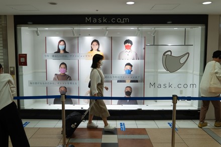 Shopper Wearing Face Mask Walks Past Editorial Stock Photo - Stock