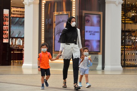 Shopper Wearing Face Mask Walks Past Editorial Stock Photo - Stock