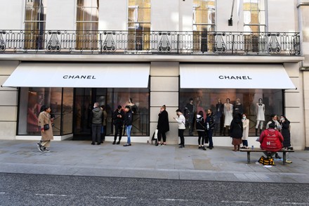 Shoppers Queue Outside Chanel Store On Editorial Stock Photo