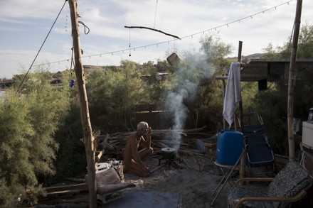 NATURIST CAMPER COOKS DINNER HIS TENT Editorial Stock Photo - Stock