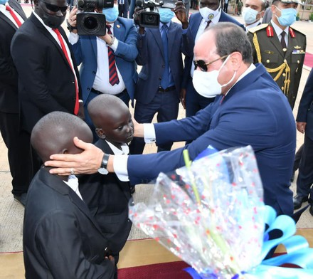 Egypt's President Abdel Fattah al-Sisi and South Sudan's President Salva Kiir, wearing protective face masks, stand as they listen to national anthems, Juba, Sudan - 28 Nov 2020