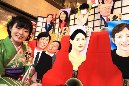 Japanese dollmaker Kyugetsu displays hagoita wooden racket with depiction of this year's news makers, Tokyo, Japan - 03 Dec 2020