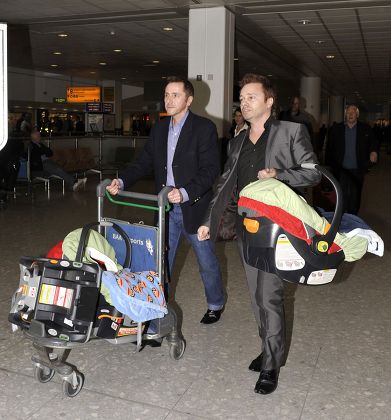 Britains first gay surrogate fathers, Barrie and Tony Drewitt-Barlow at Heathrow Airport, London, Britain  - 01 Mar 2010