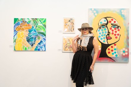 Artist Tatiana Lisovskaya poses with her work. One Art Space in Tribeca held an opening reception for their 5th Annual International Women's Day Art Fair. The exhibition features a diverse, international collection of talent, female-identifying artists of varying ages.