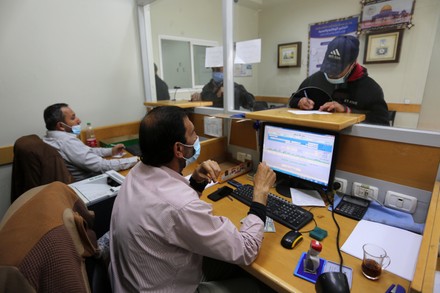 Palestinians wear protective face masks, as they wait to receive their financial aid, amid the coronavirus disease (COVID-19) outbreak, at the Post Office, Dair Al Balah, Gaza Strip, Palestinian Territory - 07 Mar 2021