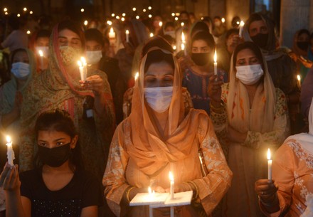 Christian worshipers pray and hold candles during an Easter vigil mass at Don Bosco Church, Lahore, Punjab, Pakistan - 03 Apr 2021
