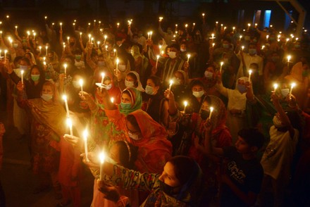 Christian worshipers pray and hold candles during an Easter vigil mass at Don Bosco Church, Lahore, Punjab, Pakistan - 03 Apr 2021
