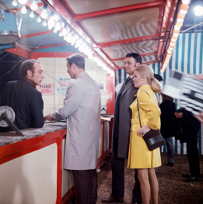Fairground Concessionaire, as played by Ron Pember, Jeannie Hopkirk, as played by Annette Andre, Emil Cavallo-Smith, as played by Barrie Ingham, and Police Sergeant Bodyguard, as played by Richard Owens