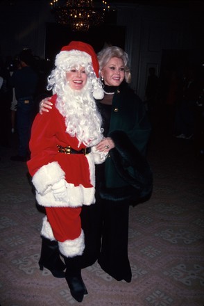 Actress sisters Eva wearing Santa Claus suit and Zsa Zsa, USA
