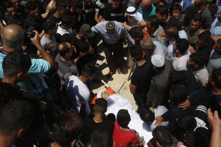 Mourners carry the body of Palestinian teenager Ahmed Zahi Bani Shamsa ...