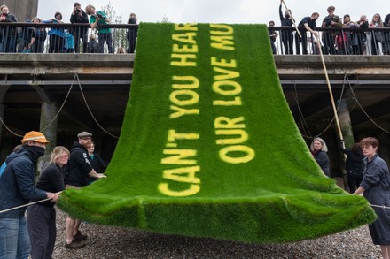 Extinction Rebellion Floats A Message In Grass On The Thames In London, United Kingdom - 25 Jun 2021