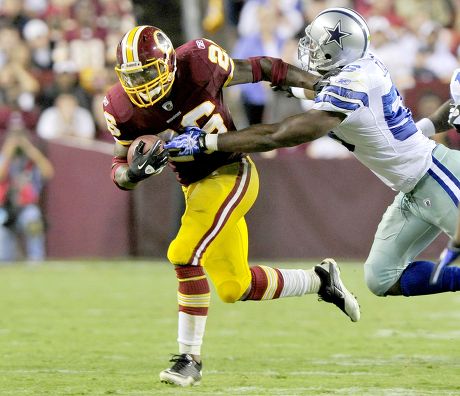 LeBron James tosses the football before the beginning of the game as the Dallas  Cowboys faced the Washington Redskins at FedEx Field in Landover, Maryland,  Sunday, September 12, 2010. (Photo by Ron