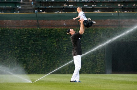 Chicago Cubs pitcher Kerry Wood plays with his son Justin, 2, in the  outfield after the Cubs beat the St. Louis Cardinals 5-4 to clinch the N.L.  Central Division at Wrigley Field