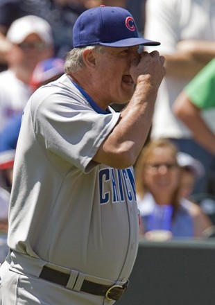 Chicago Cubs manager Lou Piniella (C) chases second base umpire Chris  Guccione while trailed by first base umpire Jim Reynolds during the second  inning against the Colorado Rockies at Coors Field in