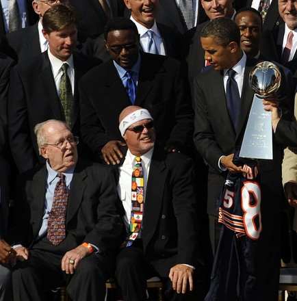 U.S. President Barack Obama hands over the Vince Lombardi Trophy