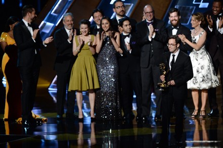 Head writer Elliott Kalan (at mic) with crew accepts the award for Outstanding Writing for a Variety Series for 'The Daily Show with Jon Stewart'  onstage during the 67th Primetime Emmy Awards in the Microsoft Theater in Los Angeles on September 20, 2015.