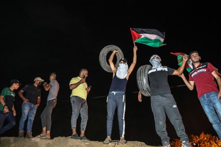 Palestinian protesters gather during a demonstration along the border between the Gaza Strip and Israel east of Khan Younis, Khan Younis, Gaza Strip, Palestinian Territory - 30 Aug 2021