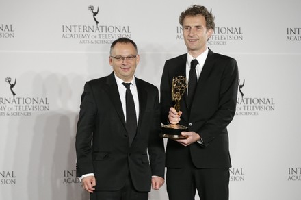 Derek Wax and Euros Lyn stand with the 'TV Movie/Mini-Series' award in the press room at the 44th International Emmy Awards at the New York Hilton in New York City on November 21, 2016.