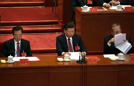 China's Xi, Hu and Jiang review documents during the Comunist Party of China congress in Beijing, China - 24 Oct 2017
