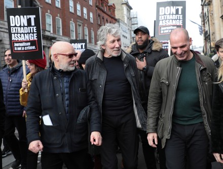 L-R Musician Brian Eno, Roger Waters and politician Yanis Varoufakis walk in protest with hundreds of activists fighting to stop the extradition of Julian Assange to the United States for committing espionage charges against the American government on Saturday, February 22, 2020 in London. The trial to extradite Julian Assange begins on Monday in London on February 24 2020.