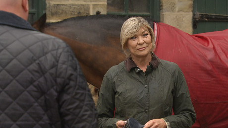 Emmerdale - Ep 9156
Monday 20th September 2021
Desperate Paddy Kirk, as played by Dominic Brunt, has nowhere else to turn and finds himself outside Home Farm asking for Kim Tate's, as played by Claire King, help to get rid of Al. Kim argues that getting Al out of HOP would actually be in her interests so she needs Paddy to sweeten the deal for her.