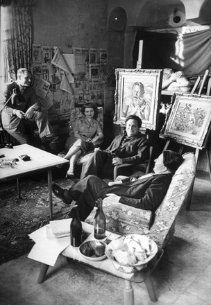 Author Alberto Moravia, Novelist Elsa Moranti, Author Carlo Levi and Carlo Muscetta sitting in Levi's private studio., Rome, Italy