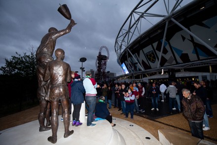 Supporters / Fans take a look at the newly unveiled London Stadium statue of the three West Ham legendary 1966 World Cup & 1965 European Cup Winners' Cup winning players: Sir Geoff Hurst, Bobby Moore and Martin Peters.