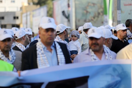 Palestinians take part in a march marking the 10th anniversary of prisoners swap deal between Hamas and Israel, in Gaza city, Gaza city, Gaza Strip, Palestinian Territory - 18 Oct 2021